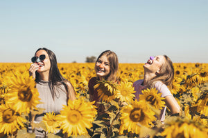 Colorful sunscreen on nose girls persons people laughing under the sun with sunscreen on nose colorful sunscreen sunflower field under the sun reef safe spf for face
